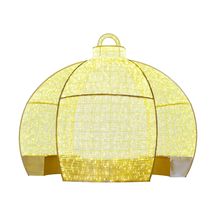 A large, illuminated Christmas ornament, from the back view, shaped like a ball, made of gold wire with a handle at the top. The ornament is decorated with festive lights, making it a popular decoration for homes and businesses during the holiday season.