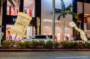 Giant illuminated Christmas prop hat and illuminated wave prop in city median on Rodeo Drive, Beverly Hills