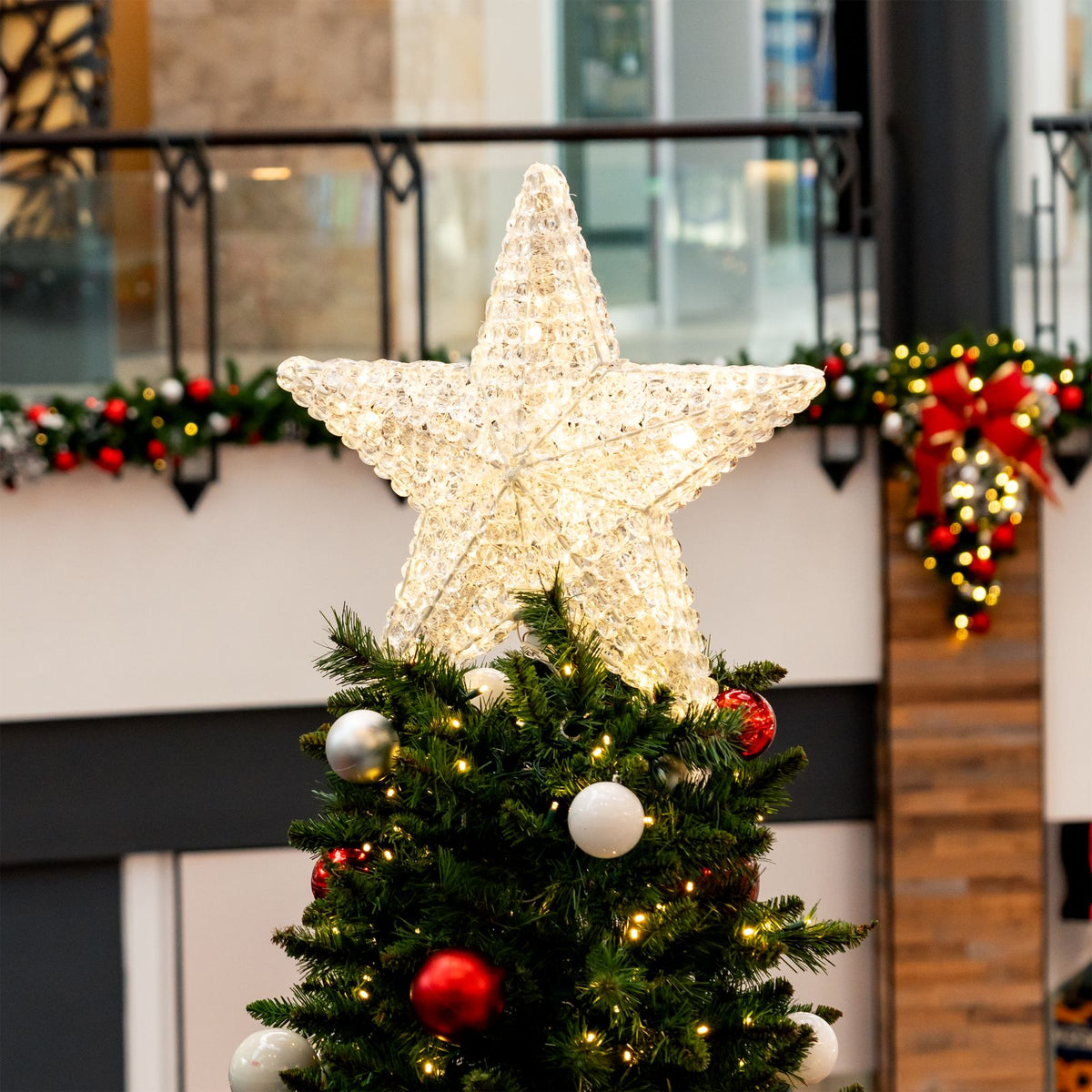 Dekra-Lite Warm White Crystal Star Tree Topper on a tree